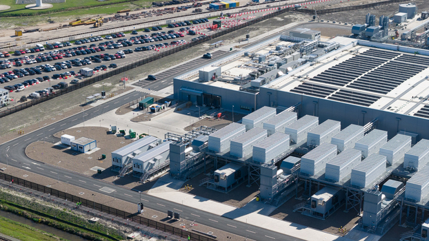 Aerial view of the Westpoort industrial facility with rows of cooling units and a large parking lot under bright daylight in Groningen Groningen Netherlands.