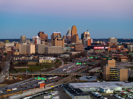 Aerial view of the vibrant skyline of Cincinnati where the distinctive Great American Tower pierces the horizon near the bustling Paul Brown Stadium. Cincinnati Ohio United States. Aerial view of the vibrant skyline of Cincinnati where the distinctive Great American Tower pierces the horizon near the bustling Paul Brown Stadium. Cincinnati Ohio United States.