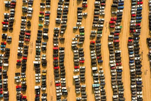 Aerial view of the Open Beatz Festival parking lot with hundreds of colorful cars parked in neat rows on a dirt field Herzogenaurach Bayern Germany. Aerial view of the Open Beatz Festival parking lot with hundreds of colorful cars parked in neat rows on a dirt field Herzogenaurach Bayern Germany.