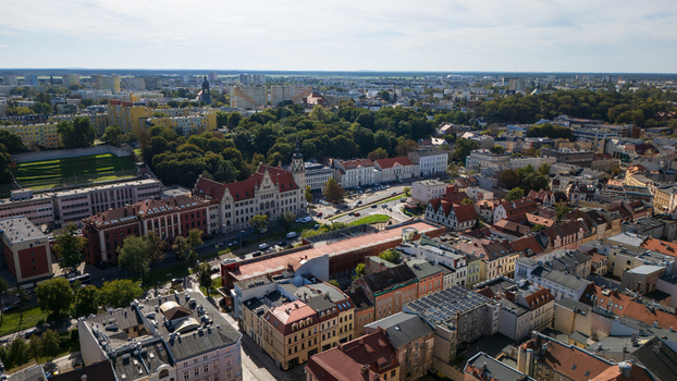 Aerial view of the city with buildings of red roofs green trees and old architecture under the bright sky Bydgoszcz Województwo kujawsko pomorskie Poland. Aerial view of the city with buildings of red roofs green trees and old architecture under the bright sky Bydgoszcz Województwo kujawsko pomorskie Poland.