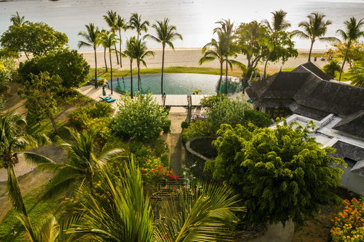 Aerial view of a luxury tropical resort with a swimming pool and palm trees along the coast in Mauritius Moka District Mauritius. Aerial view of a luxury tropical resort with a swimming pool and palm trees along the coast in Mauritius Moka District Mauritius.