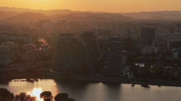 Aerial view of modern buildings and lake at sunset Albania. Aerial view of modern buildings and lake at sunset Albania.