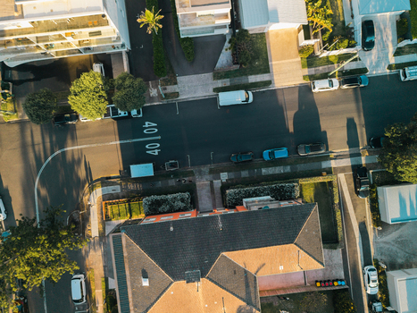 Aerial view of a residential street with parked cars houses and road markings in Dee Why New South Wales Australia. Aerial view of a residential street with parked cars houses and road markings in Dee Why New South Wales Australia.