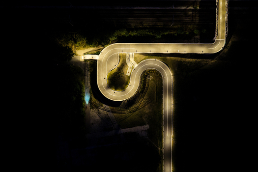 Aerial view of the illuminated Hilde Archenhold Brucke pedestrian bridge winding through the dark landscape at night in Berlin Berlin Germany. Aerial view of the illuminated Hilde Archenhold Brucke pedestrian bridge winding through the dark landscape at night in Berlin Berlin Germany.