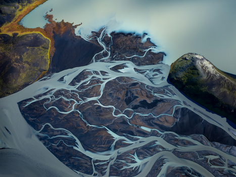 Aerial view of a complex braided river system with glacial meltwater channels winding through the dark volcanic landscape of the Iceland Highlands Iceland. Aerial view of a complex braided river system with glacial meltwater channels winding through the dark volcanic landscape of the Iceland Highlands Iceland.