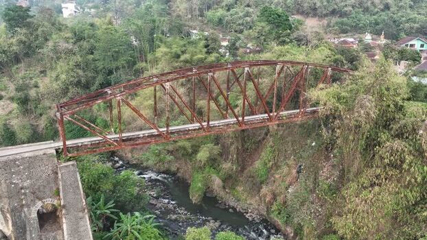 Aerial view of rusty metal bridge over river in Indonesia. Aerial view of rusty metal bridge over river in Indonesia.