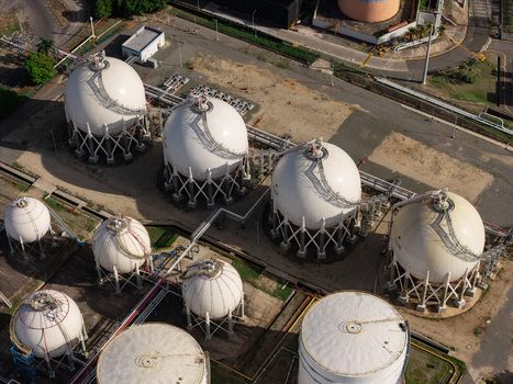 Aerial view of white spherical gas storage tanks connected by pipelines at an industrial facility in Bajos de Haina San Cristobal Province Dominican Republic.