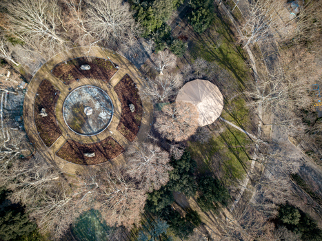 Aerial view of a circular stone plaza and a round pavilion structure surrounded by bare trees in a public park in Bologna Emilia Romagna Italy. Aerial view of a circular stone plaza and a round pavilion structure surrounded by bare trees in a public park in Bologna Emilia Romagna Italy.