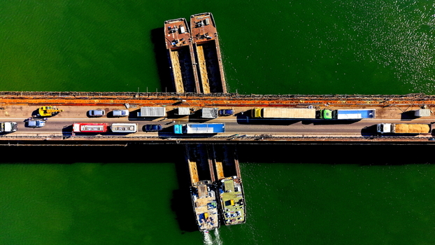 Aerial view of Smederevo Fortress bridge with heavy traffic and cargo barges navigating the Danube river in Smederevo Podunavlje District Serbia.