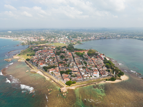 Aerial view of the historic Galle Fort with its colonial architecture stone ramparts and lighthouse surrounded by the turquoise Indian Ocean Galle Southern Province Sri Lanka. Aerial view of the historic Galle Fort with its colonial architecture stone ramparts and lighthouse surrounded by the turquoise Indian Ocean Galle Southern Province Sri Lanka.