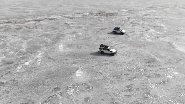 Aerial view of off road vehicles on the salt flats of Danakil Desert Ethiopia. Aerial view of off road vehicles on the salt flats of Danakil Desert Ethiopia.