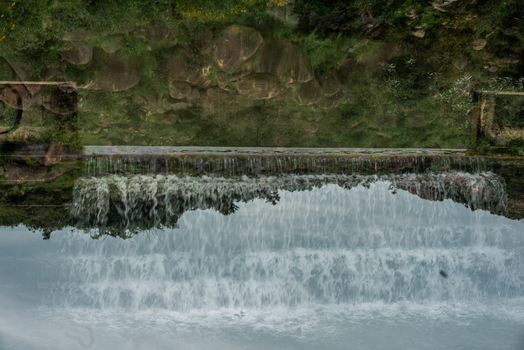 View of a cascading waterfall with lush green vegetation and rocky terrain in Jos North Plateau Nigeria. View of a cascading waterfall with lush green vegetation and rocky terrain in Jos North Plateau Nigeria.