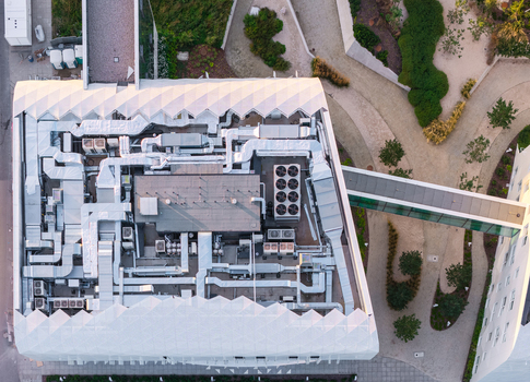 Aerial view of the modern medical resort featuring complex rooftop HVAC systems and a glass pedestrian bridge connecting to adjacent structures Sopot Pomeranian Voivodeship Poland. Aerial view of the modern medical resort featuring complex rooftop HVAC systems and a glass pedestrian bridge connecting to adjacent structures Sopot Pomeranian Voivodeship Poland.