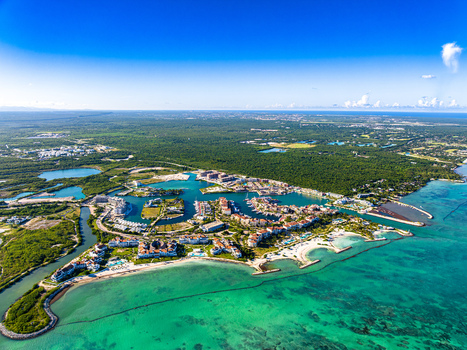 Aerial view of Cap Cana Marina featuring luxury resorts turquoise waters and boats along the coastline in Punta Cana La Altagracia Provinc Dominican Republic. Aerial view of Cap Cana Marina featuring luxury resorts turquoise waters and boats along the coastline in Punta Cana La Altagracia Provinc Dominican Republic.