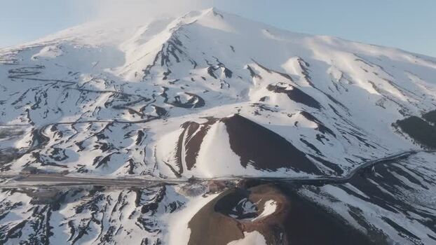 Aerial view of Rifugio Sapienza and snowy craters on Mount Etna Italy. Aerial view of Rifugio Sapienza and snowy craters on Mount Etna Italy.