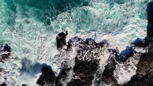 Aerial view of waves crashing on rocks at Kalaemamo United States.