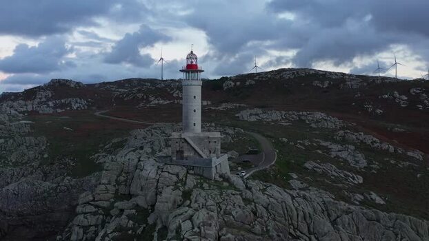 Aerial view of Faro de Punta Nariga on rocky cliffs Spain.