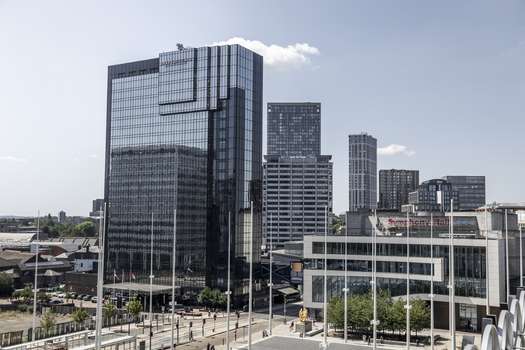 Aerial view of the Hyatt Regency hotel and Symphony Hall in the city center featuring modern glass architecture and urban streets in Birmingham England United Kingdom.