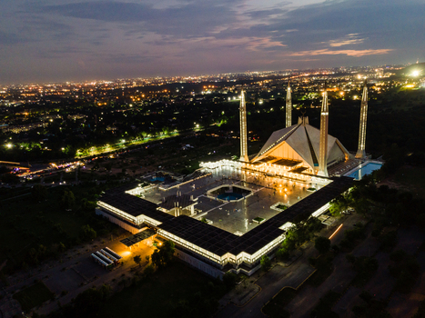 Aerial view of Faisal Mosque illuminated at night with city lights and twilight sky in Islamabad Islamabad Capital Ter Pakistan. Aerial view of Faisal Mosque illuminated at night with city lights and twilight sky in Islamabad Islamabad Capital Ter Pakistan.