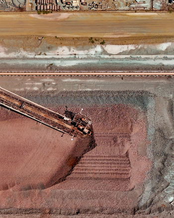 Aerial view of a large scale mining operation with conveyor machinery loading and stockpiling mineral rich material in Rustenburg North West South Africa. Aerial view of a large scale mining operation with conveyor machinery loading and stockpiling mineral rich material in Rustenburg North West South Africa.