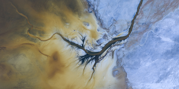 Aerial view of the abstract mineral patterns and salt crusts of Searles Lake with branching dark channels San Bernardino County California United States. Aerial view of the abstract mineral patterns and salt crusts of Searles Lake with branching dark channels San Bernardino County California United States.
