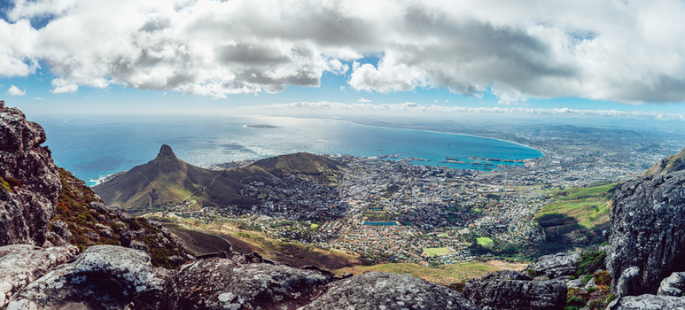 View of Lion s Head peak and the urban sprawl of the city bowl overlooking the Atlantic Ocean under a cloudy sky in Cape Town Western Cape South Africa. View of Lion s Head peak and the urban sprawl of the city bowl overlooking the Atlantic Ocean under a cloudy sky in Cape Town Western Cape South Africa.
