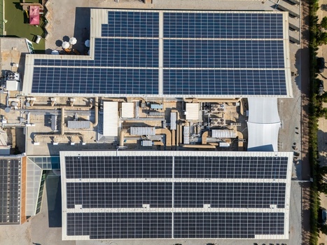 Aerial view of solar panels installed on a large commercial building roof with HVAC systems and ventilation ducts in Cascais Lisboa Portugal. Aerial view of solar panels installed on a large commercial building roof with HVAC systems and ventilation ducts in Cascais Lisboa Portugal.