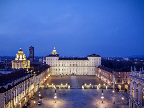 Aerial view of the illuminated Royal Palace and the Chapel of the Holy Shroud at dusk in Turin Piedmont Italy.