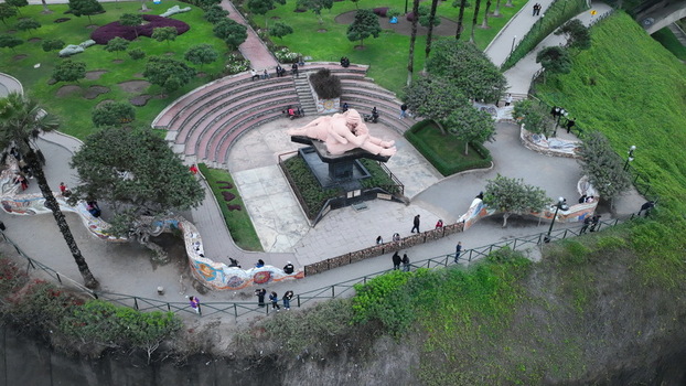 Aerial view of the Parque del Amor with the iconic El Beso sculpture mosaic walls and landscaped gardens overlooking the Pacific Ocean in Miraflores Provincia de Lima Peru.