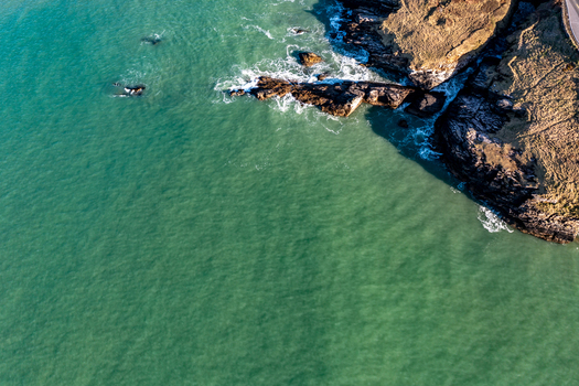Aerial view of the rugged coastline with turquoise water rocky cliffs and crashing waves Portnablagh County Donegal Ireland. Aerial view of the rugged coastline with turquoise water rocky cliffs and crashing waves Portnablagh County Donegal Ireland.