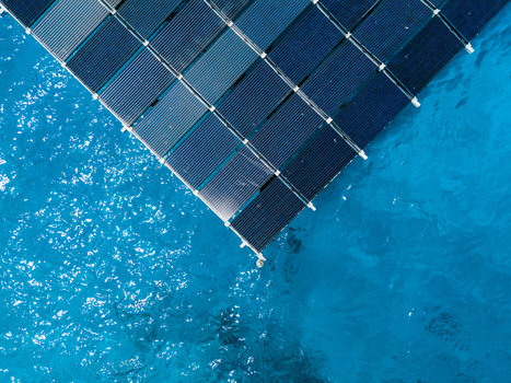 Aerial view of the SolarSea floating solar power plant by Swimsol with blue panels on turquoise water in Dharavandhoo Baa Atoll Maldives. Aerial view of the SolarSea floating solar power plant by Swimsol with blue panels on turquoise water in Dharavandhoo Baa Atoll Maldives.