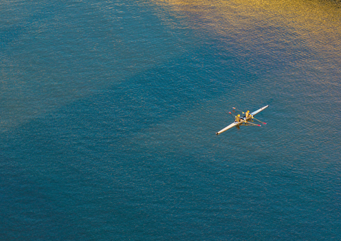 Aerial view of a rowing boat with two rowers gliding across the Vistula River in Gdansk Pomeranian Voivodeship Poland. Aerial view of a rowing boat with two rowers gliding across the Vistula River in Gdansk Pomeranian Voivodeship Poland.