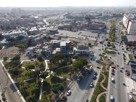 Aerial view of the urban landscape of San Juan de Miraflores featuring busy roads with traffic a green park and surrounding buildings in San Juan de Miraflores Lima Peru. Aerial view of the urban landscape of San Juan de Miraflores featuring busy roads with traffic a green park and surrounding buildings in San Juan de Miraflores Lima Peru.