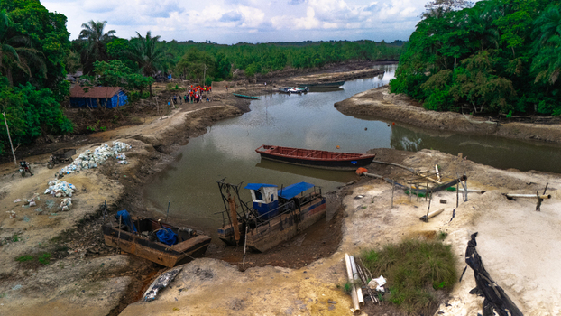 Aerial view of small boats and dredging equipment moored in the river at Buguma Rivers Nigeria.