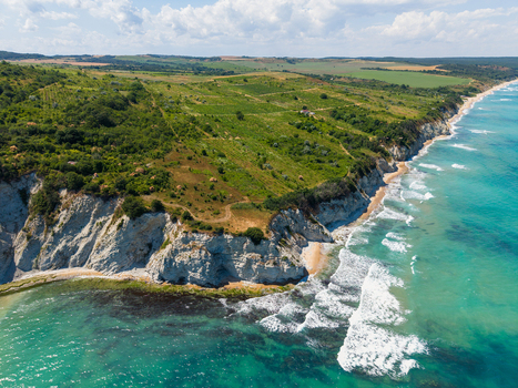 Aerial view of the rugged white cliffs and lush green hills along the Black Sea coastline in Byala Varna Bulgaria. Aerial view of the rugged white cliffs and lush green hills along the Black Sea coastline in Byala Varna Bulgaria.