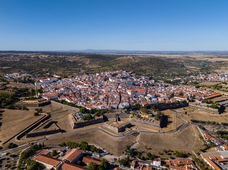 Aerial view of the historic star shaped fortifications and white washed buildings of the old town surrounded by the rolling landscape of the Alentejo region in Elvas Portalegre Portugal. Aerial view of the historic star shaped fortifications and white washed buildings of the old town surrounded by the rolling landscape of the Alentejo region in Elvas Portalegre Portugal.