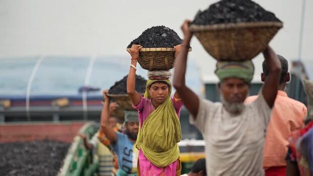 View of workers carrying coal baskets at Aminbazar Bangladesh. View of workers carrying coal baskets at Aminbazar Bangladesh.