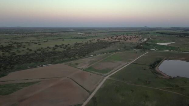 Aerial view of rural fields and a pond at dusk in Portugal. Aerial view of rural fields and a pond at dusk in Portugal.