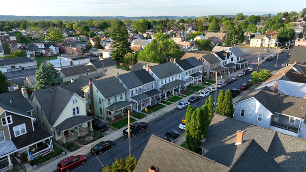Aerial view of a residential street featuring historic homes parked cars and mature trees in Ephrata Pennsylvania United States.