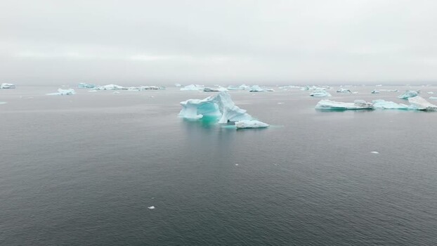 Aerial view of icebergs floating in the sea Greenland. Aerial view of icebergs floating in the sea Greenland.