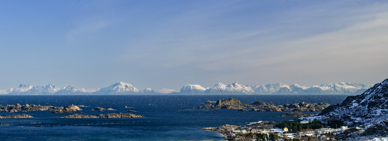 Nordland Norway 21 September 2026 Aerial view of Lofoten featuring snow capped mountain peaks rocky islands and deep blue sea under a clear sky. Nordland Norway 21 September 2026 Aerial view of Lofoten featuring snow capped mountain peaks rocky islands and deep blue sea under a clear sky.