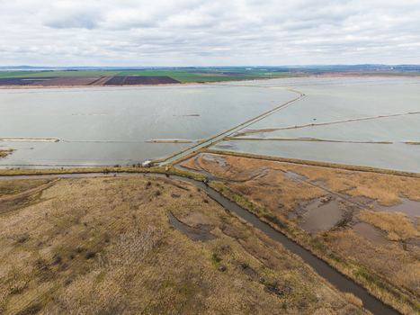 Aerial view of Lake Atanasovsko featuring salt pans narrow canals and dry reeds under a cloudy sky in Burgas Burgas Bulgaria. Aerial view of Lake Atanasovsko featuring salt pans narrow canals and dry reeds under a cloudy sky in Burgas Burgas Bulgaria.