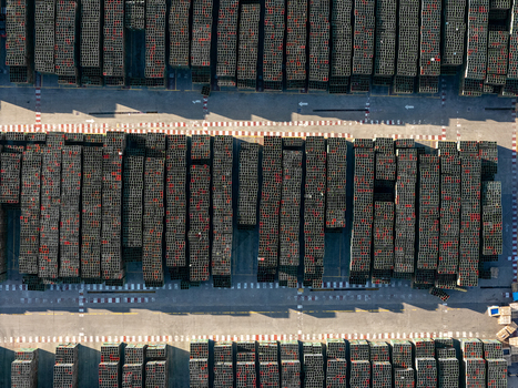 Aerial view of the beer industrial complex featuring rows of stacked crates arranged in a geometric pattern within the storage yard in Santo Domingo Dominican Republic. Aerial view of the beer industrial complex featuring rows of stacked crates arranged in a geometric pattern within the storage yard in Santo Domingo Dominican Republic.
