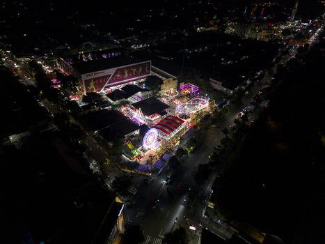 Aerial view of GOR Gelarsena Klaten Night Market with a Ferris wheel colorful amusement rides and illuminated streets at night Kecamatan Klaten Utara Jawa Tengah Indonesia. Aerial view of GOR Gelarsena Klaten Night Market with a Ferris wheel colorful amusement rides and illuminated streets at night Kecamatan Klaten Utara Jawa Tengah Indonesia.