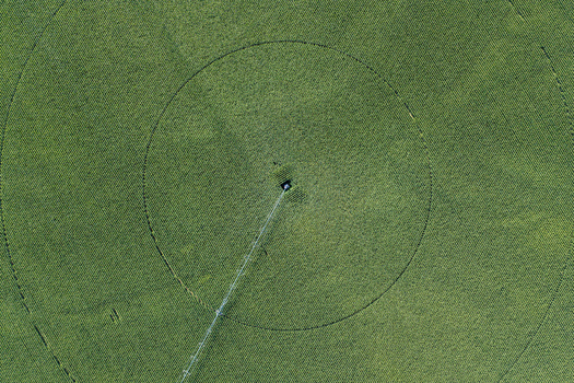 Aerial view of a center pivot irrigation system in a lush green agricultural field in Hombourg Grand Est France. Aerial view of a center pivot irrigation system in a lush green agricultural field in Hombourg Grand Est France.