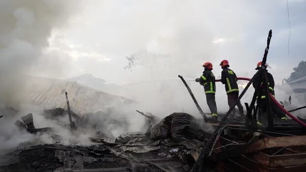 View of firefighters battling a fire in Khagrachari Bangladesh. View of firefighters battling a fire in Khagrachari Bangladesh.