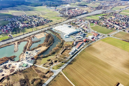 Aerial view of the town of Buttenheim showing the industrial zone residential areas and vast agricultural landscape under a bright sky in Buttenheim Bavaria Germany. Aerial view of the town of Buttenheim showing the industrial zone residential areas and vast agricultural landscape under a bright sky in Buttenheim Bavaria Germany.