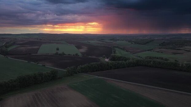Aerial view of rolling fields under a dramatic sunset Czechia.