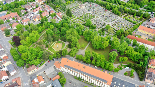 Aerial view of Stadtpark with lush green trees a nearby cemetery and residential houses in Forchheim Bayern Germany. Aerial view of Stadtpark with lush green trees a nearby cemetery and residential houses in Forchheim Bayern Germany.