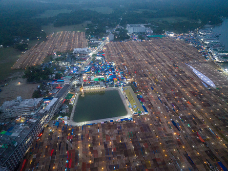 Aerial view of the bustling market a vibrant tapestry of stalls and pathways illuminated by countless lights reflecting the energy of Charmonai Barisal Division Bangladesh. Aerial view of the bustling market a vibrant tapestry of stalls and pathways illuminated by countless lights reflecting the energy of Charmonai Barisal Division Bangladesh.